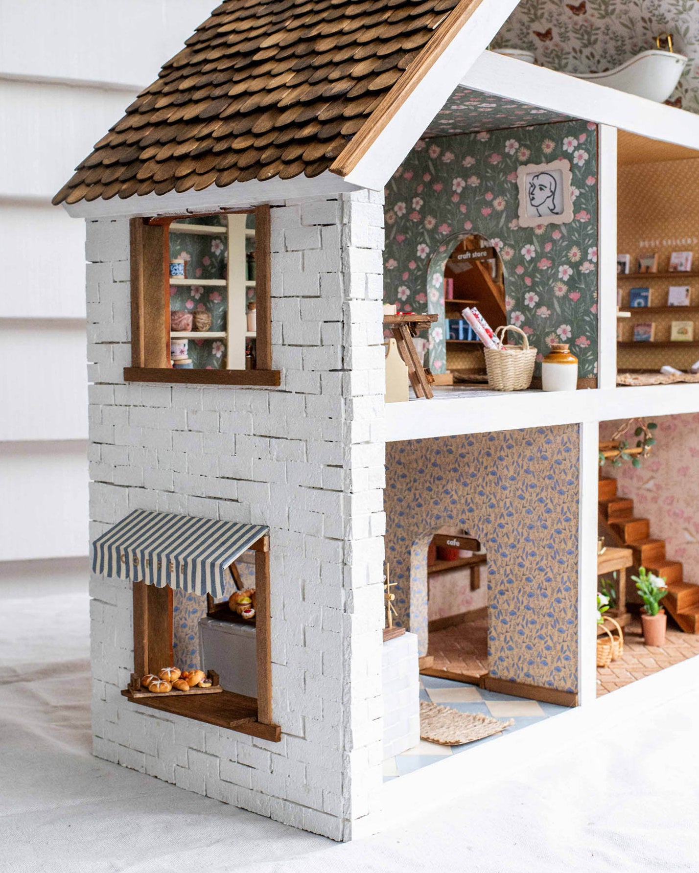 Detailed dollhouse with interior rooms and furniture.